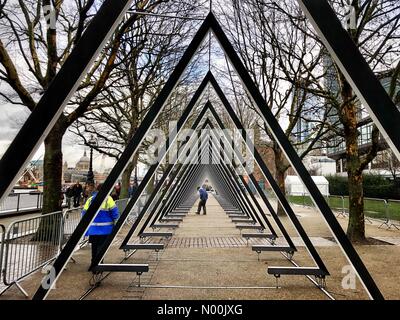 London, UK. 15th January, 2018.  Workers on the Riverside Walkway setting up The Wave, an installation consisting of 40 triangular, interactive luminous gates, ready for the Lumiere London festival. South Bank, London, England, UK. Credit: Jamie Gladden/StockimoNews/Alamy Live News Stock Photo