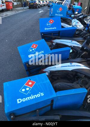 East Finchley, London. 18th Jan, 2018. UK Weather: Domino's delivery scooters simulate falling dominos after strong winds knocked them over in East Finchley in London on January 18 2018 Credit: Louisa Cook/StockimoNews/Alamy Live News Stock Photo