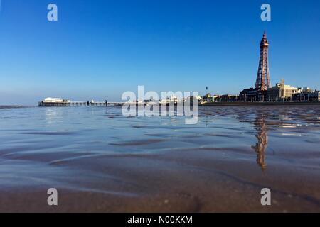 UK Weather: Sunny at Blackpool. Clear blue skies but cold wind on the beach at Blackpool with the Tower and North pier Stock Photo