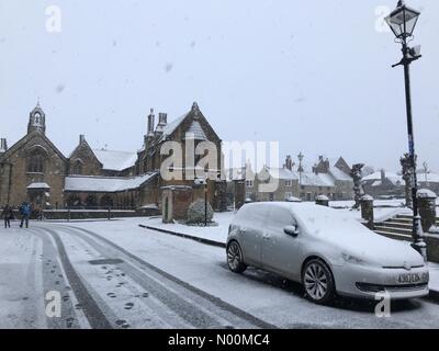 UK Weather: Sherborne, Dorset. Snow falls on St Johns Almshouses in the historic Sherborne Abbey as the so called mini Beast from the East brings another icy blast to the South West. Stock Photo