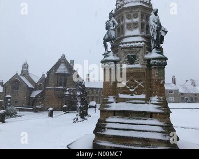 UK Weather: Sherborne, Dorset. Snow falls on St Johns Almshouse and the Digby Memorial in historic Sherborne as the so called mini Beast from the East brings another icy blast to the South West. Stock Photo