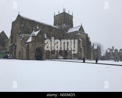 UK Weather: Sherborne, Dorset. Snow falls on Sherborne Abbey in the historic market town of Sherborne as the so called mini Beast from the East brings another icy blast to the South West. Stock Photo