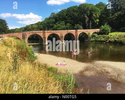 UK Weather- Bathers in River Wye - Bredwardine, Herefordshire, UK - Families enjoy a swim and paddle in the River Wye on a hot sunny day with local temps of 26c. Stock Photo