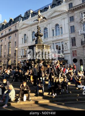 London, UK. 21st Oct 2018. People enjoying the October sunshine on Eros in Piccadilly Circus in central London. Credit: Andym/StockimoNews/Alamy Live News Stock Photo