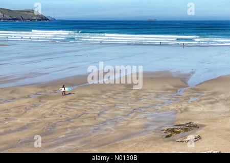 Polzeath beach, Cornwall. 20th May 2020. UK Weather: Lone surfer on an almost deserted Polzeath beach, Cornwall Credit: nidpor/StockimoNews/Alamy Live News Stock Photo