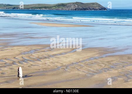 Polzeath beach, Cornwall. 20th May 2020. UK Weather: Lone surfer on an almost deserted Polzeath beach, Cornwall Credit: nidpor/StockimoNews/Alamy Live News Stock Photo