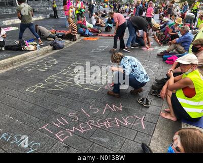 Cardiff, Wales, UK. 1st September, 2020. Extinction Rebellion protest Cardiff - Tuesday 1st September 2020 - XR climate protestors chalk climate emergency message outside the Welsh Parliament in Cardiff Bay Credit: Steven May/StockimoNews/Alamy Live News Stock Photo