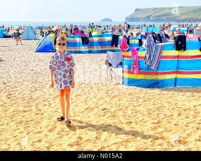 Polzeath, Cornwall, UK. 25th July, 2021. UK Weather: sunshine and colourful wind breaks on a hot crowded Polzeath beach at the start of the Summer holidays. Polzeath, Cornwall, UK. 25th July, 2021. Credit: nidpor Credit: nidpor/StockimoNews/Alamy Live News Stock Photo