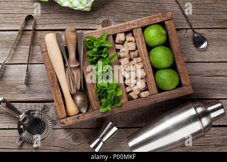 Mojito cocktail ingredients and bar accessories box on wooden table. Top view Stock Photo