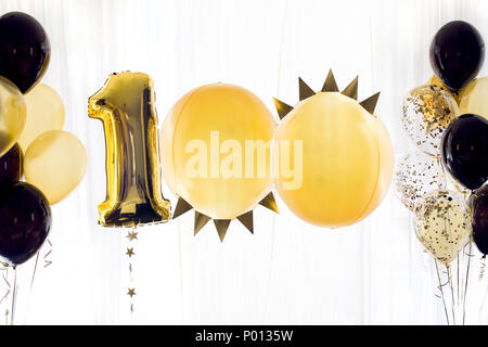 Yellow black helium balloon number one hundred 100 Stock Photo