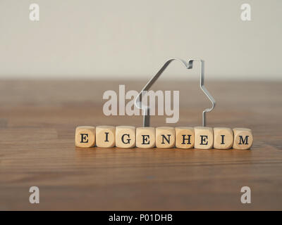 German new home concept with wooden dices and a house shape Stock Photo