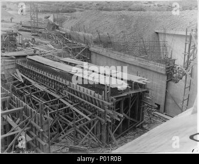 Stewart Mountain Dam. View looking downstream of partly completed right wall with piers 13-14 and supported floor... - Stock Photo