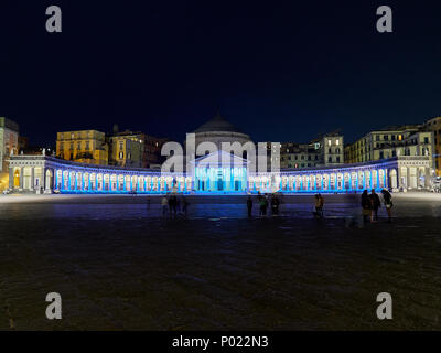 Panoramic view of blue illuminated at night Piazza del Plebiscito on square with people in Napoli Stock Photo