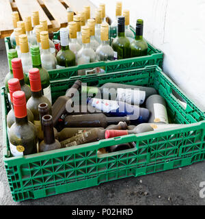 Notodden, Norway - May 20, 2018: Travel documentary of everyday life and place. Two plastic crates filled with old and empty bottles. Stock Photo