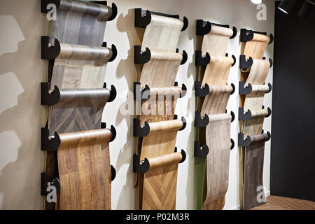 Rolls with samples of linoleum for the floor in the store Stock Photo