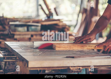 Background image of woodworking workshop: carpenters work table with different tools and wood cutting stand, vintage filter image Stock Photo