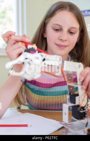 Female Pupil In Science Lesson Studying Robotics Stock Photo