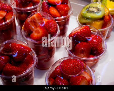 strawberry and kiwi fruit salads in plastic cups at the central market of Valencia, spain Stock Photo