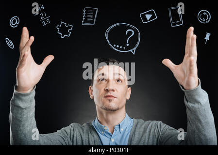 Clever web developer putting his hands up and looking confident Stock Photo