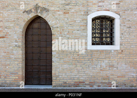 Wooden door and window on the facade of an historic building