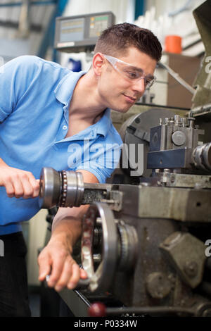 Male Engineer Operating Lathe In Factory Stock Photo