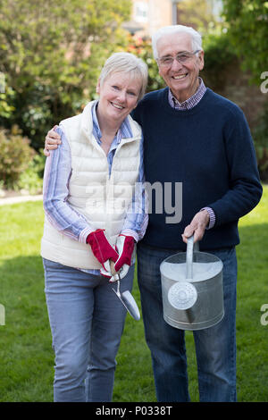 Portrait Of Senior Couple Working In Garden Together Stock Photo