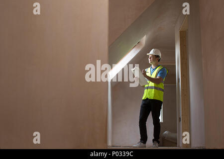 Inspector On Building Site With Clipboard Stock Photo