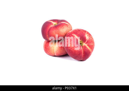 Three fresh red flat peaches on a white background Stock Photo