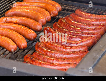 barbecue scenery with roasted sausages on a grill Stock Photo
