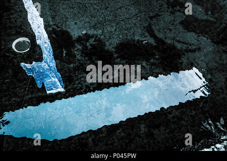 reflex on water with trash items on it Stock Photo
