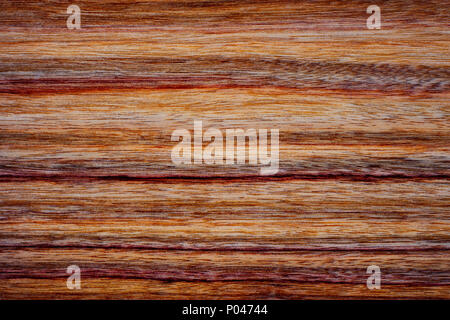 Natural stained rich exotic wood background pattern. Stock Photo