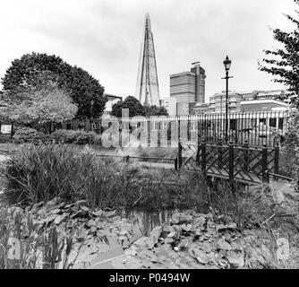 a very different view of The Shard, London with a pond in the foreground in black and white Stock Photo