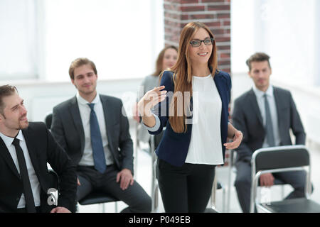 Businesswoman Addressing Delegates At Conference Stock Photo