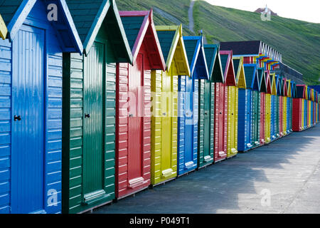 f brightly painted beach huts at Whitby on the Yorkshire coast Stock Photo