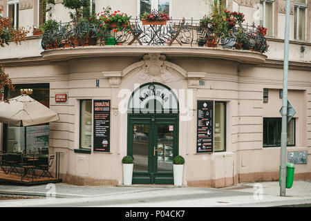 Prague, September 24, 2017: The corner of the traditional building with the Czech architecture with balconies and flowers. Entrance to an authentic ca Stock Photo