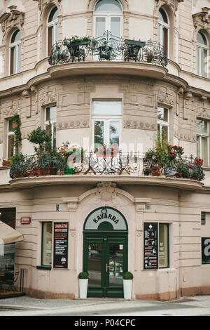 Prague, September 24, 2017: The corner of the traditional building with the Czech architecture with balconies and flowers. Entrance to an authentic ca Stock Photo