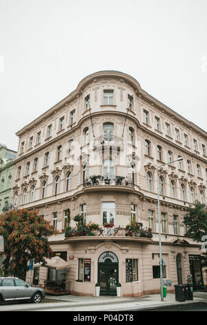 Prague, September 24, 2017: The corner of the traditional building with the Czech architecture with balconies and flowers. Entrance to an authentic ca Stock Photo