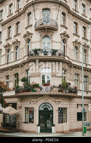 Prague, September 24, 2017: The corner of the traditional building with the Czech architecture with balconies and flowers. Entrance to an authentic ca Stock Photo