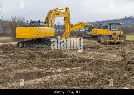 two yellow excavators at a loamy construction site Stock Photo - Alamy