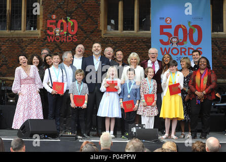 The Duchess of Cornwall (centre right) on stage with celebrities including Amanda Abbingdon, Shobna Gulati, Dara O' Briain, David Walliams, Jim Broadbent, Jason Issacs, Chris Evans and the six winning children at the live broadcast of the final of BBC Radio 2's 500 Words creative writing competition at Hampton Court Palace in East Molesey. Stock Photo