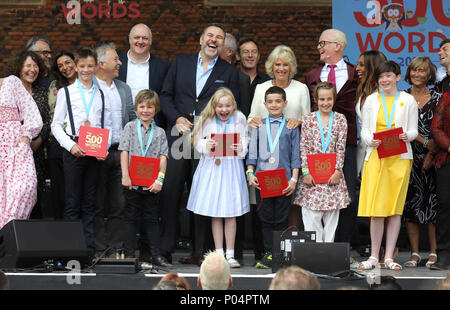 The Duchess of Cornwall (centre right) on stage with celebrities including Shobna Gulati, Dara O' Briain, David Walliams, Jason Issacs, Chris Evans and the six winning children at the live broadcast of the final of BBC Radio 2's 500 Words creative writing competition at Hampton Court Palace in East Molesey. Stock Photo