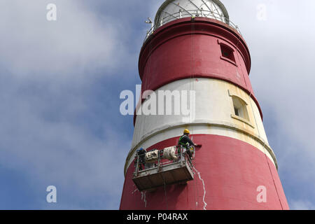 Happisburgh Lighthouse, near Cromer in Norfolk, is repainted with its iconic red and white hoops for the first time since 2009. Stock Photo