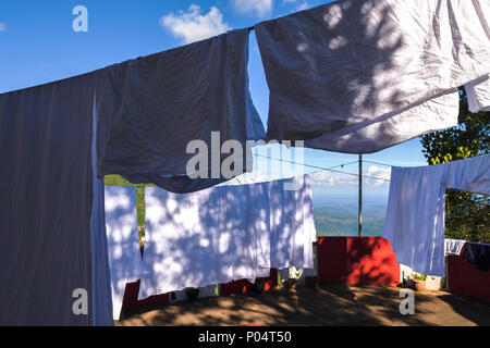 White clothes drying on fresh air outdoor. Stock Photo