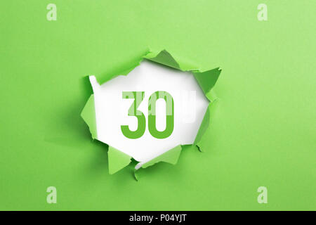 Green Number 86 on green paper background Stock Photo