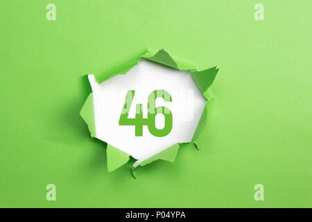 Green Number 102 on green paper background Stock Photo