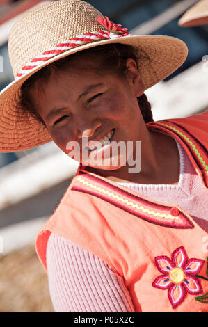 Local residents welcome tourist visiters to Uros, the floating Islands in Peru Stock Photo