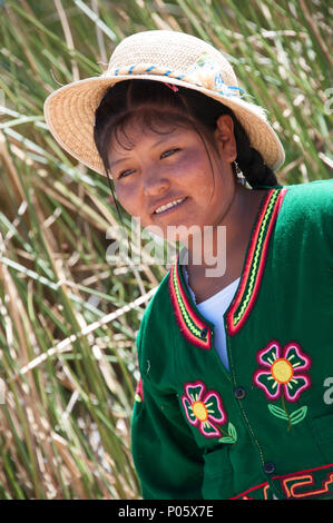 Local residents welcome tourist visiters to Uros, the floating Islands in Peru Stock Photo