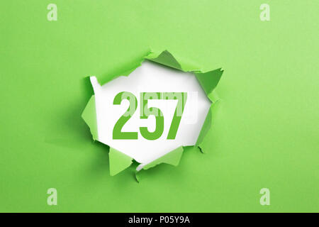 Green Number 257 on green paper background Stock Photo