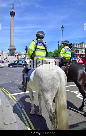 Mounted police in Trafalgar Square, London, England, UK. Nelson's Column Stock Photo