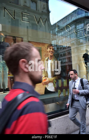 Office workers, tourists and pedestrians walk past branches of New Look on the junction of Gracechurch and Lombard Street in the City of London. The h Stock Photo